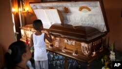 A boy looks at the coffin holding the body of Candido Rios Vazquez, a journalist for the Diario de Acayucan newspaper, who was murdered in Hueyapan de Ocampo in Veracruz state, Mexico, Aug. 23, 2017. Rios reportedly had been threatened repeatedly since 2012 by a former mayor of Hueyapan de Ocampo.