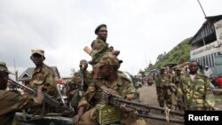 Congolese rebels sit in a truck as they patrol a street in Sake, 25 kilometers north of Goma city soon after the rebels captured the town from the government army, in the eastern Democratic Republic of Congo, November 21, 2012.