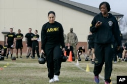 U.S. Army Staff Sgt. Idis Arroyo,left, carries weights while training to serve as an instructor in the new Army combat fitness test at Fort Bragg, N.C., Jan. 8, 2019.