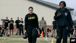 U.S. Army Staff Sgt. Idis Arroyo,left, carries weights while training to serve as an instructor in the new Army combat fitness test at Fort Bragg, N.C., Jan. 8, 2019.