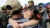 A girl falls asleep on her father's shoulders as they wait with other survivors to be airlifted to Manila, in the aftermath of super typhoon Haiyan at the Tacloban airport, Nov. 14, 2013.