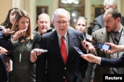 FILE - U.S. Senate Majority Leader Mitch McConnell, R-Ky., is surrounded by reporters as he returns from meeting with President Donald Trump and Democratic leaders at the White House, at the U.S. Capitol in Washington, Jan. 2, 2019.