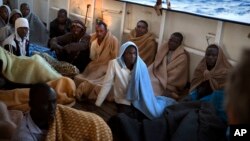 Men sit on the deck of the Golfo Azzurro rescue vessel after being rescued by members of the Spanish ONG Open Arms on the mediterranean sea, north of Zuwarah, Libya, June 21, 2017.