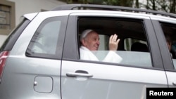 Pope Francis greets journalists as he leaves Assumption Residence in Sumare neighborhood in the north of Rio de Janeiro July 24, 2013. 