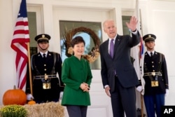 Vice President Joe Biden waves to reporters as South Korean President Park Geun-hye arrives for lunch at the Naval Observatory in Washington, Oct. 15, 2015.