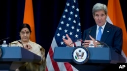 Secretary of State John Kerry, joined by Indian External Affairs Minister Sushma Swaraj, speaks to reporters at the State Department in Washington, Sept. 22, 2015.