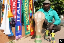Madziwana sells an assortment of soccer paraphernalia- including scarves, flags and even replicas of the World Cup made from beads and wire