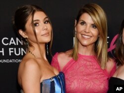 Actress Lori Loughlin poses with her daughter Olivia Jade Giannulli, left, at the 2019 "An Unforgettable Evening" in Beverly Hills, California, Feb. 28, 2019.