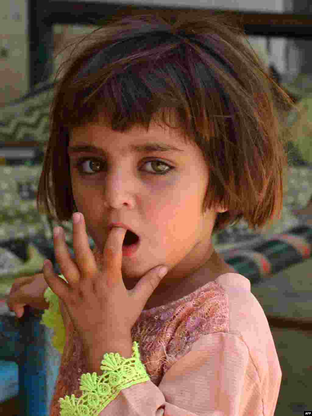 An internally displaced girl from North Waziristan looks on while taking shelter with her family at a school in Bannu, Pakistan.