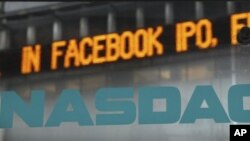 News about the Facebook IPO passes on a billboard outside of NASDAQ in Times Square, New York, May 15, 2012.