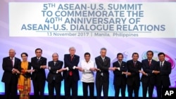 Leaders from left to right, Malaysia's Prime Minister Najib Razak, Myanmar's State Councellor and Foreign Minister Aung San Suu Kyi, Thailand's Prime Minister Prayut Chan-ocha, Vietnam's Prime Minister Nguyen Xuan Phuc, U.S. President Donald Trump, Philippine President Rodrigo Duterte, Singapore's Prime Minister Lee Hsien Loong, Brunei's Sultan Hassanal Bolkiah, Cambodia's Prime Minister Hun Sen, Indonesia's President Joko Widodo and Laos Prime Minister Thongloun Sisoulith, pose for a family photo during the ASEAN-US Summit in Manila on Monday Nov. 13, 2017. 
