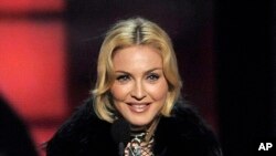 FILE - Madonna accepts the award for top touring artist at the Billboard Music Awards in Las Vegas.