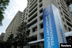 FILE - The International Monetary Fund headquarters building is seen in Washington.