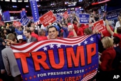 Alaska delegate Saul Soltero waves a Trump flag during the final day of the Republican National Convention in Cleveland, July 21, 2016.