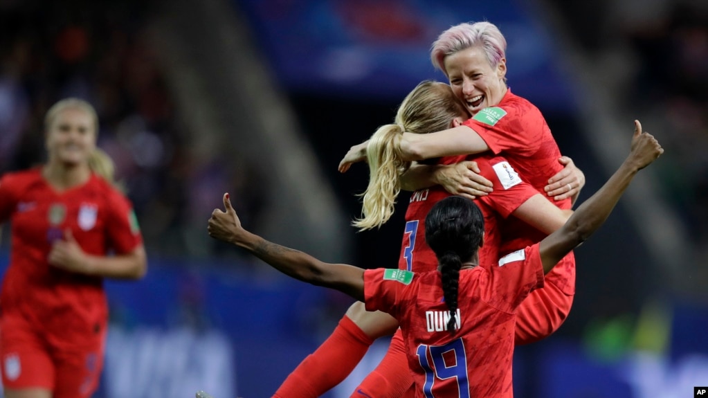 United States' scorer Samantha Mewis lifts her teammate Megan Rapinoe as she celebrates her side's 4rth goal during the Women's World Cup soccer match between United States and Thailand June 11, 2019. (AP Photo/Alessandra Tarantino)