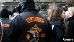 FILE - Members of motorcycle gang 'Bandidos' wait in front the regional court in Muenster.