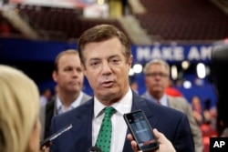 FILE - Paul Manafort, then chairman of Republican Donald Trump's presidential campaign, talks to reporters on the floor of the Republican National Convention at Quicken Loans Arena in Cleveland, July 17, 2016.