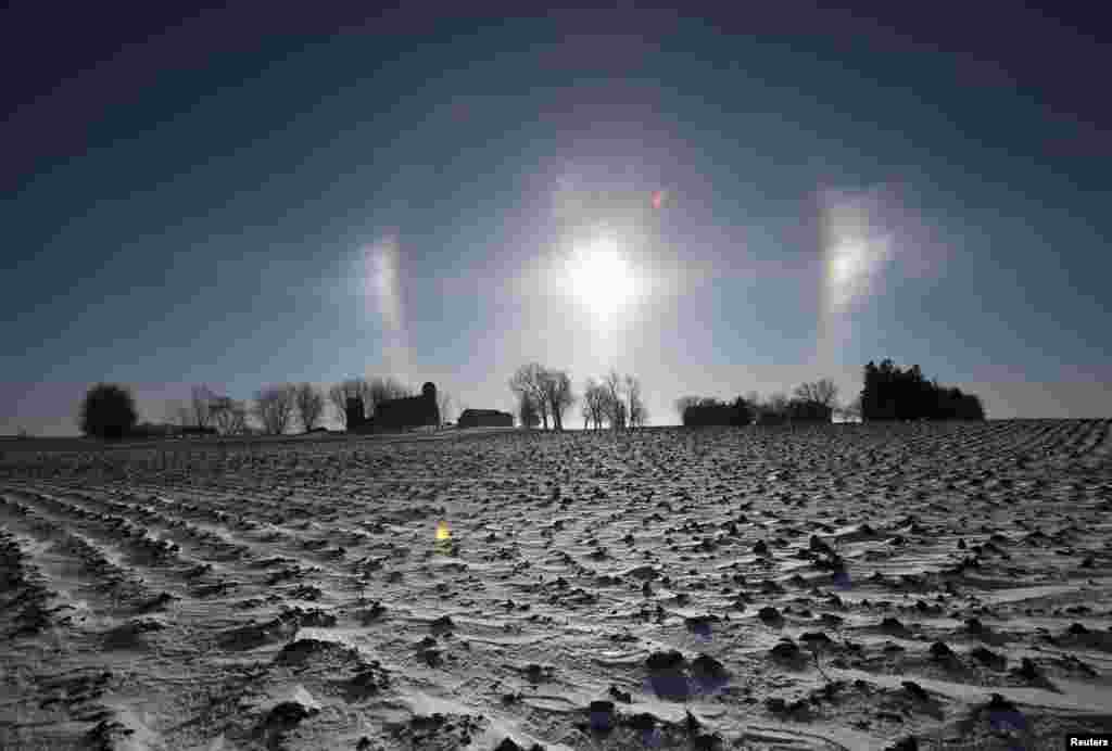 A "sun dog" atmospheric phenomenon appears over a farm in southern Minnesota. Chicago, Minneapolis and other parts of the upper Midwest will have two consecutive days of subzero highs on Monday and Tuesday, according to forecasters.