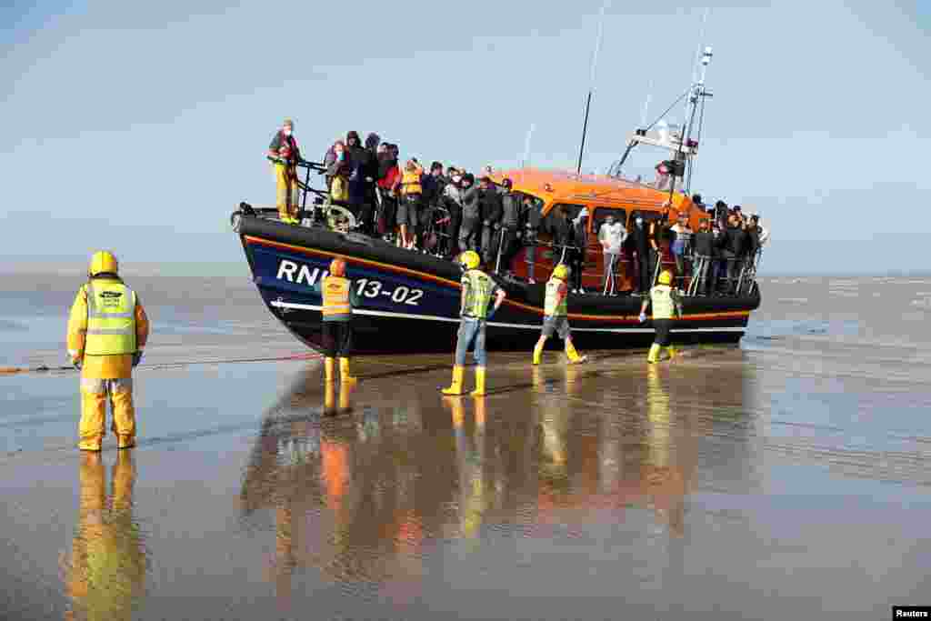 Migrants rescued from the English Channel arrive on a Royal National Lifeboat Institution (RNLI) boat at Dungeness, Britain.