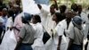 FILE - Zimbabwean riot policemen stand in front of doctors and nurses who are demonstrating over the deteriorating health system, outside Parirenyatwa group of hospitals in Harare, Nov. 18, 2008.