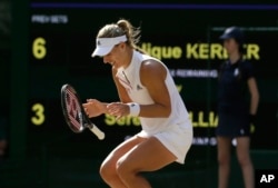 Germany's Angelique Kerber celebrates after winning the women's singles final match against Serena Williams of the United States, at the Wimbledon Tennis Championships, in London, July 14, 2018.