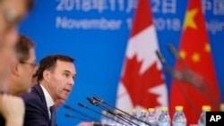 FILE - Canadian Finance Minister Bill Morneau speaks at the first China-Canada economic and financial strategy dialogue in Beijing, Nov. 12, 2018. 