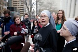 FILE - Sister Loraine, of Little Sisters of the Poor, speaks to members of the media after attending a hearing in the 10th U.S. Circuit Court of Appeals, in Denver, Colorado, Dec. 8, 2014.