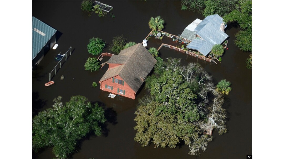 A home sits in floodwaters in Nichols, South Carolina, Oct. 10, 2016. Nearly 1 million homes and businesses still did not have power Monday morning in the Carolinas after Hurricane Matthew.