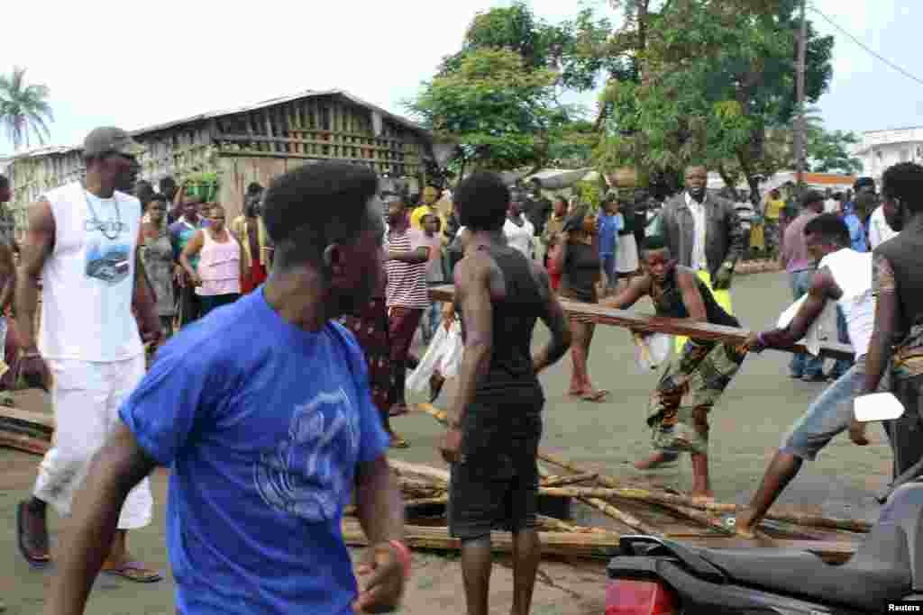 Residents place roadblocks on the street to demand faster removal of dead bodies infected with Ebola virus in the Aberdeen district of Freetown, Sierra Leone, Oct. 14, 2014.