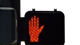 A U.S. street light displays the red image that means 