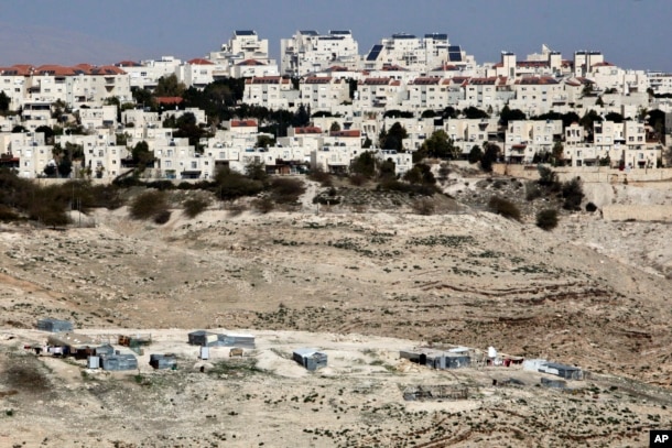 The Israeli settlement of Maaleh Adumim looms over Arab Bedouin shacks in the West Bank, Jan. 22, 2017.