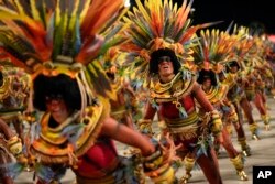 FILE - Performers from the Salgueiro samba school parade during Carnival celebrations at the Sambadrome in Rio de Janeiro, Brazil, February 12, 2024.