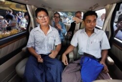 Reuters reporters Wa Lone and Kyaw Soe Oo react in a vehicle after being freed from Insein prison after receiving a presidential pardon in Yangon, Myanmar, May 7, 2019.