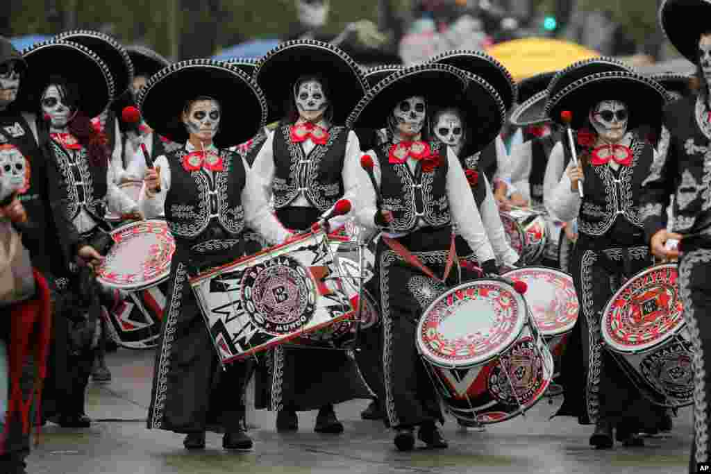Performers participate in the Day of the Dead parade in Mexico City, Nov. 2, 2019.