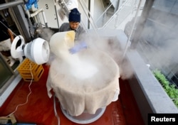 Yoshimi Terasawa, chief brewer at Tokyo Port Brewing, works to steam rice as a part of brewing sake, traditional rice wine, at the brewery in Tokyo, Japan July 9, 2024. (REUTERS/Kim Kyung-Hoon)