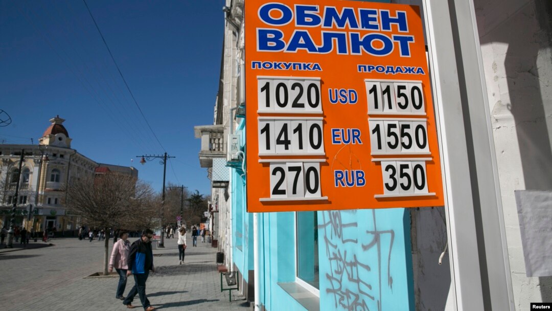 A sign displaying currency rates is seen in Simferopol, Crimea March 22, 2014.