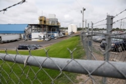 Business continues at this Koch Foods Inc., plant in Morton, Miss.,, Aug. 8, 2019, following Wednesday's raid by U.S. immigration officials. More than 300 of the 680 people arrested have been released from custody.