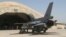 FILE - One of four new U.S.-made F-16 fighter jets outside a hardened hangar upon its arrival to Balad Air Base, north of Baghdad, Iraq, July 2015. Documents and interviews describe schemes at the air base that were major contract violations or illegal.