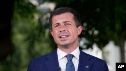 Transportation Secretary Pete Buttigieg talks with reporters at the White House July 23, 2024. Regulators are investigating how Delta Air Lines is treating passengers affected by canceled and delayed flights as the airline struggles to recover from a global technology outage.