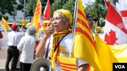 Protesters rally against human right abuses in Vietnam during President Truong Tan Sang's visit to the White House, in Washington, D.C., July 25, 2013.