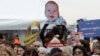 The face of Israeli hostage Kfir Bibas, a son of Shiri Bibas, beams during a tribute to Israeli hostages called by the Representative Council of French Jewish Institutions at the Trocadero Square in Paris, Feb. 21, 2025.