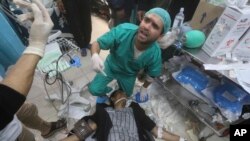 FILE - Palestinians wounded during the Israeli air and ground offensive in Khan Younis are brought to a hospital in Rafah, Gaza Strip, January 23, 2024