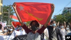Protesters against Myanmar's junta burn the flag of the Association of Southeast Asian Nations (ASEAN), in Mandalay, Myanmar, June 5, 2021.