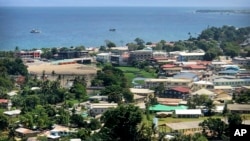 In this Nov. 24, 2018, photo, ships are docked offshore in Honiara, the capital of the Solomon Islands.