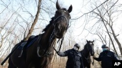 Mounted police patrol in a park in Warsaw, Poland, on March 5, 2021.
