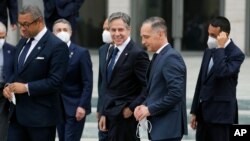 German Foreign Minister Heiko Maas, center right, and U.S. Secretary of State Antony Blinken, center left, talk after a group photo during the 'Second Berlin Conference on Libya' at the foreign office in Berlin, Germany, June 23, 2021. 