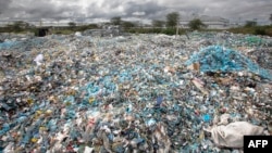 A mound of plastic waste scavenged from various environments including river channels and dump sites sit in the yard at T3 (EPZ) Limited, a recycling and repurposing factory in Athi River town, Machakos county on November 13, 2023. (Photo by Tony KARUMBA / AFP)