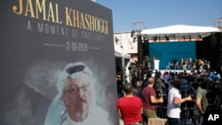 A picture of slain Saudi dissident and Washington Post columnist Jamal Kashoggi is seen during a ceremony near Saudi Arabia's consulate in Istanbul, Turkey, marking the one-year anniversary of his death, Oct. 2, 2019. 