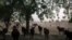 FILE - A herd of oxen crosses the road on the outskirts of Maroua, Cameroon, Feb. 20, 2018.