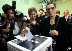 FILE - Louisa Hanoune, the only woman running for Algeria’s presidency and head of the Worker’s Party, casts her ballot to vote in the presidential elections, April, 17 2014.